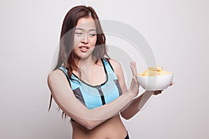 Asian healthy girl hate potato chips, junk food.