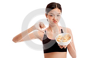 Asian healthy girl thumbs down with french fries