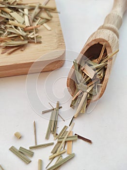 Asian herb dried lemongrass, cymbopogon on a wooden spoon