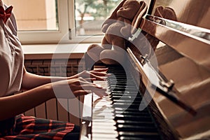 asian high school student sitting at the piano