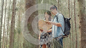 Asian hiker couple trekking in forest. Young happy backpack male and female walking enjoy her journey, travel nature and adventure