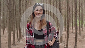 Asian hiker woman trekking in forest. Young happy backpack girl smiling to camera, travel nature and adventure trip, climb