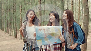 Asian hiker women trekking in forest. Young happy backpack girls walking enjoy her journey, travel nature and adventure trip,