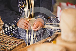 Asian hilltribe woman handcraft weaving bamboo stripe for basket or tray