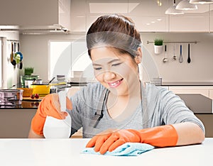 Asian housekeeper cleaning on table