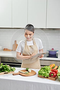 Asian housewife cooking in the kitchen