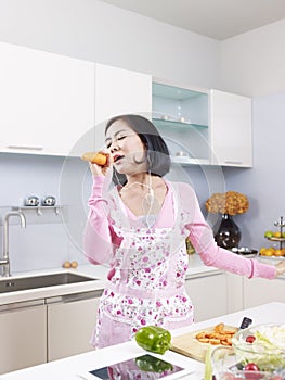 Asian housewife in kitchen