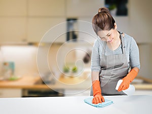 Asian housewife sweeping on table