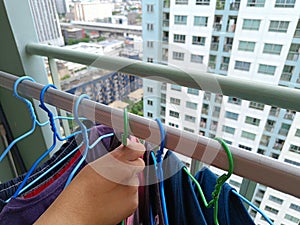 Asian housewives drying clothes on the balcony of a condo or apartment