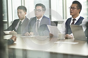 Asian HR people conducting interview in meeting room