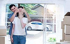 Asian husband Cover his eyes with his attractive wife While walking into the house