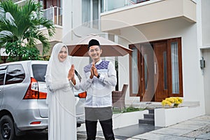 Asian husband and wife with greeting hand gestures