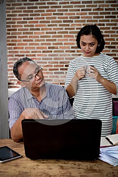 Asian Husband and Wife Having a Business Discussion at Home