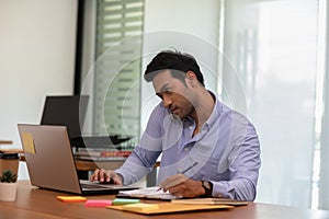 Asian indian business man talking with customer on mobile phone to get requirement and sale support