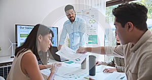 Asian Indian man lead young group of multiethnic businesspeople in team meeting, using laptop computer for ESG topic presentation