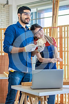 Asian Indian professional male and female engineer architect foreman labor worker lover couple wear safety goggles standing