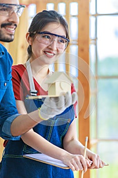 Asian Indian professional male and female engineer architect foreman labor worker lover couple wear safety goggles standing