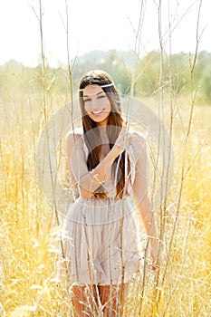 Asian indian woman walking in golden dried field