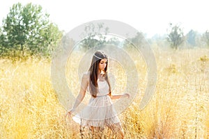 Asian indian woman walking in golden dried field