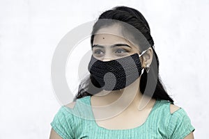 Asian / Indian woman wearing face mask against Pollution, Coronavirus or COVID-19. Isolated over white background