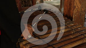 Asian Indonesian Balinese musician gamelan instrument. Closeup hands playing. Not edited, raw file.