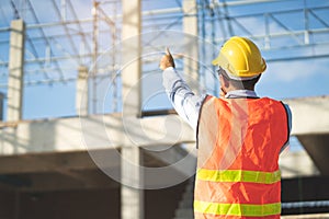 Asian inspector checking structure of new property and taking note in the clipboard for review and fix the house before sell.