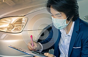 Asian Insurance Agent or Insurance Agency Wear Mask Write Car Crash Report in Zoom View in Vintage Tone