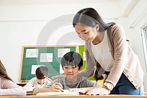 Asian Japanese boy writing at desk