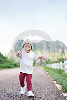 Asian Japanese child boy running at outdoor