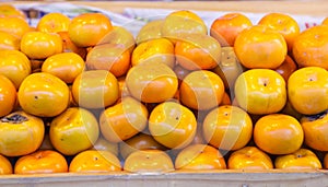 Asian or Japanese Persimmon Persimon fruits are sweet flavored with soft fibrous texture, not astringent when ripe. This ripened photo
