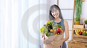 Asian Japanese woman holding shopping bag from supermarket full of organics vegetables and fruits for healthy food and vegetarian