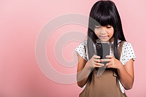 Asian kid 10 years enjoying using mobile phone for social network media
