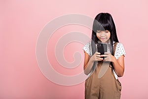 Asian kid 10 years enjoying using mobile phone for social network media