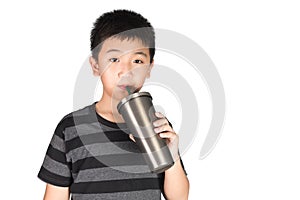 Asian kid boy holding stainless steel tumbler cup with straw, is