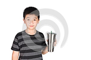 Asian kid boy holding stainless steel tumbler cup with straw, is