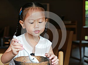 Asian kid girl eating rice delicious japanese food on table for lunch in the restaurant