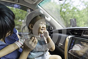Asian kid girl is happiness in the car