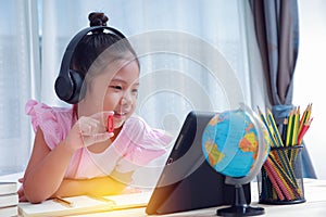 Asian kid girl wearing headphones study mathematics.