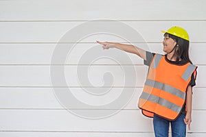 Asian Kid girl wearing reflective shirts and a hat yellow. To learning and enhance development, little architect