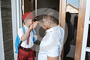 Asian kid kiss her father`s hand before going to school