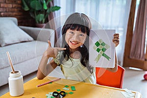 Asian kid making eid mubarak card