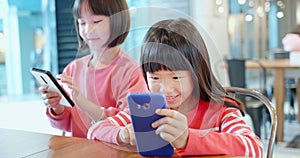 Asian kid play cell phone