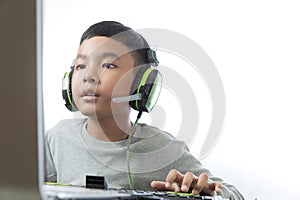 Asian kid play computer games