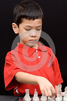 Asian kid playing chess