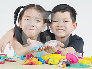 Asian kid playing colorful clay toy