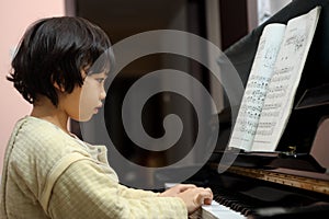 Asian kid playing piano