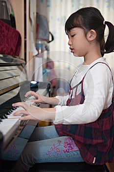 Asian kid playing piano