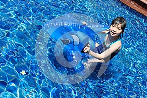 Asian kid playing in swimming pool