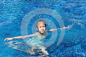 Asian kid playing in swimming pool