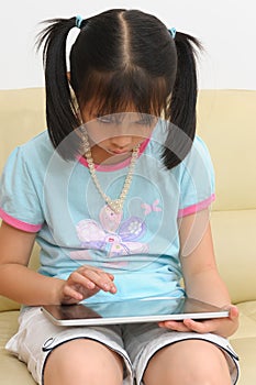 Asian kid playing with touchscreen